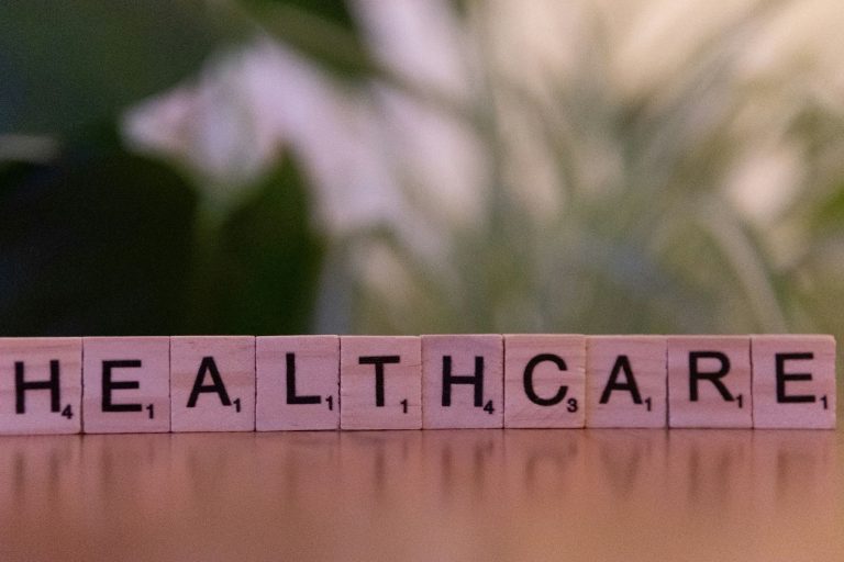 wooden letter tiles spelling healthcare on table representing business growth