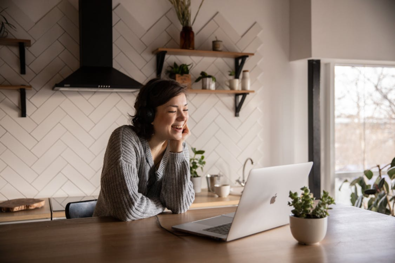 woman smiling during virtual interview on laptop at home