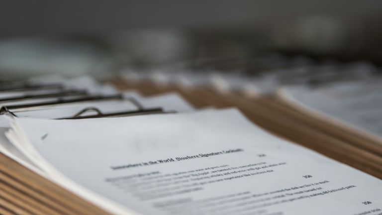 Close-up of business compliance documents and paperwork for risk management planning.