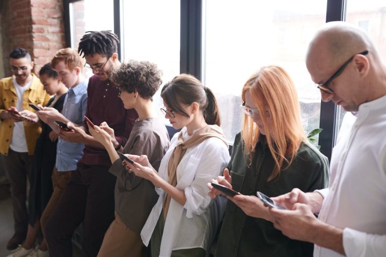 Diverse group of people using smartphones and digital technology in everyday life