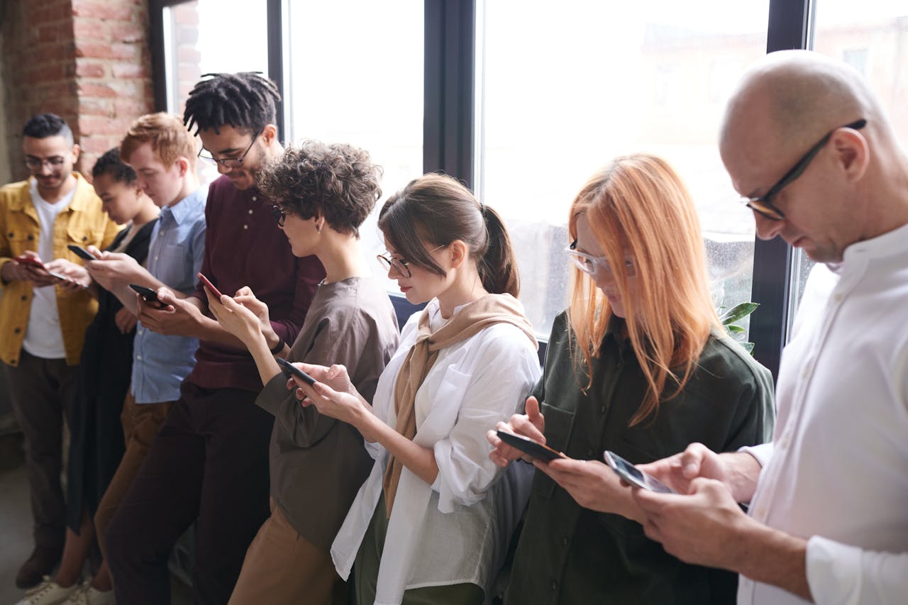 Diverse group of people using smartphones and digital technology in everyday life