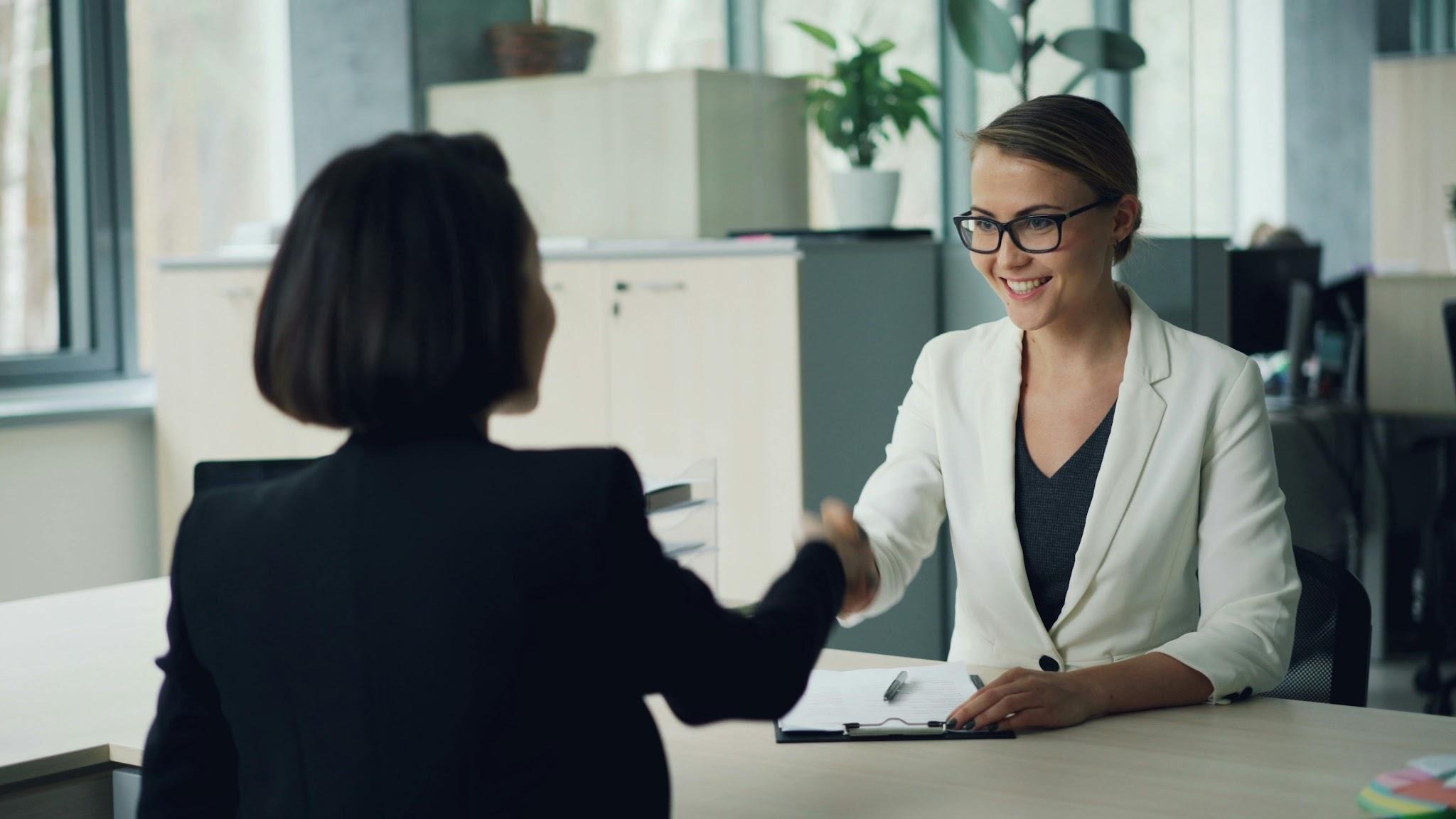 Business professionals shaking hands during a successful corporate client meeting.