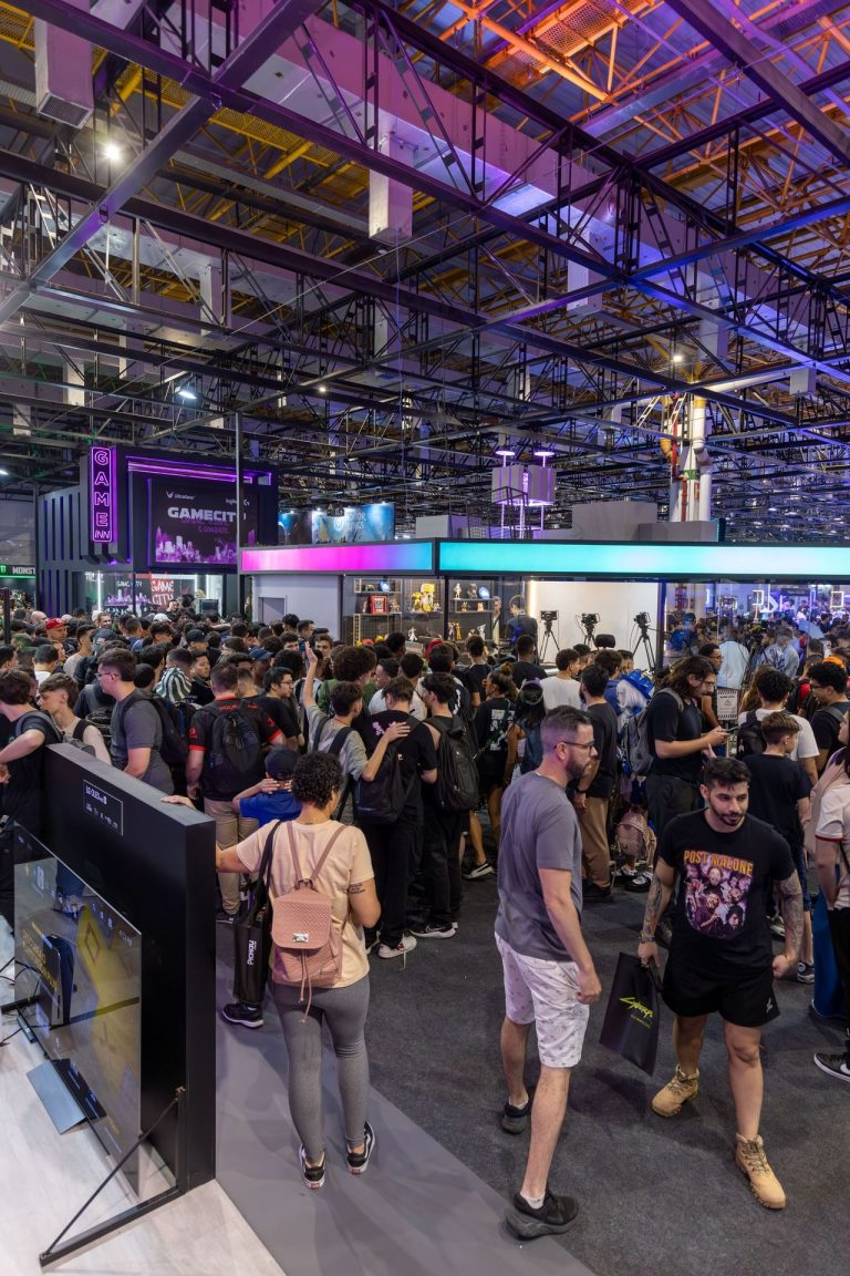 Attendees walking through a busy trade show floor while visiting exhibitor booths and networking with businesses
