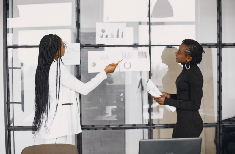 Two business professionals reviewing performance data and digital growth strategies in an office