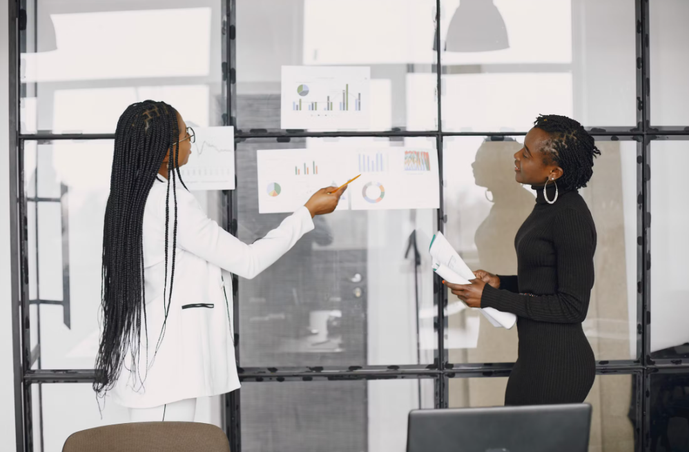 Two business professionals reviewing performance data and digital growth strategies in an office
