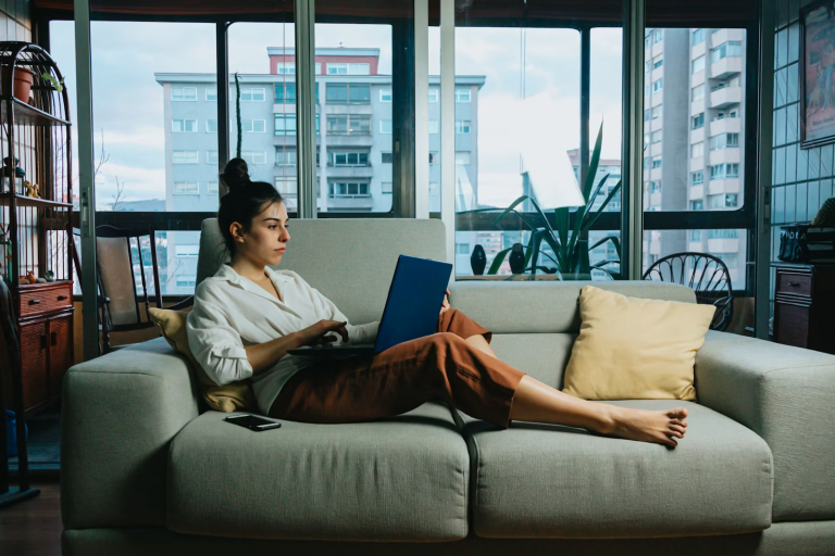 Digital entrepreneur working on a laptop from home while creating online content and growing a content-based business