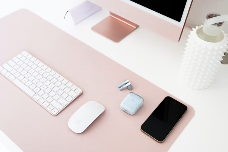 Organized workspace with computer, keyboard, smartphone, and productivity tools for business owners