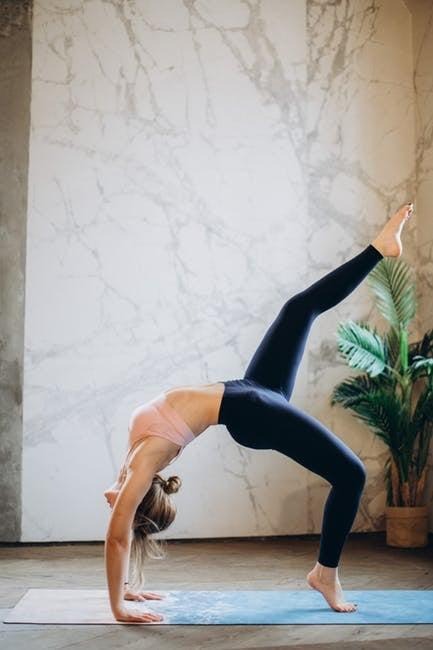 Woman practicing yoga indoors as part of a holistic wellness routine