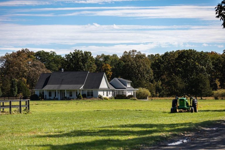 Large rural property with a home and open land showcasing income-generating real estate potential