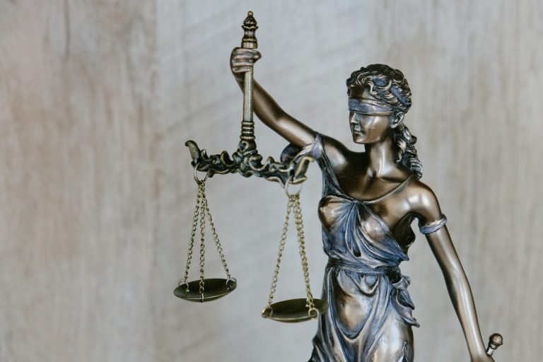 Lady Justice statue holding scales representing fairness, legal expertise, and the foundation of a successful law firm