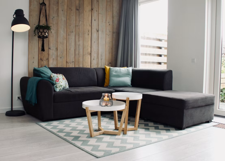 Bright, modern living room with comfortable seating, natural light, and cozy décor designed to support wellness at home.