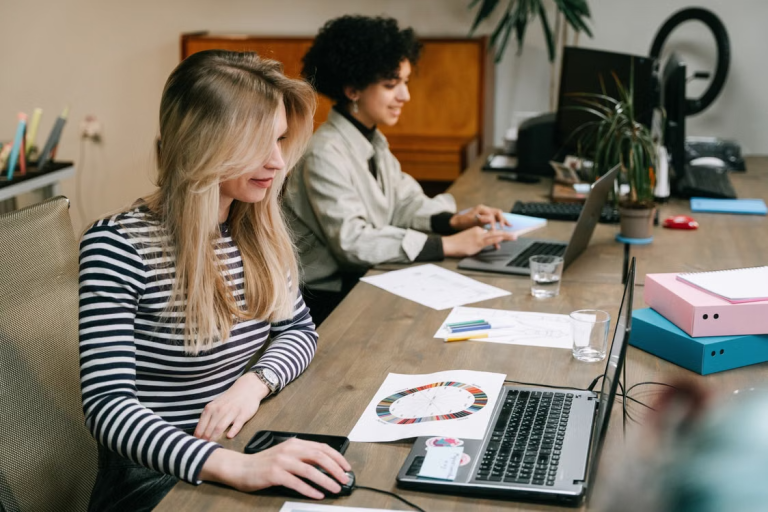 Employees working together in a modern office, representing teamwork and successful hiring practices.
