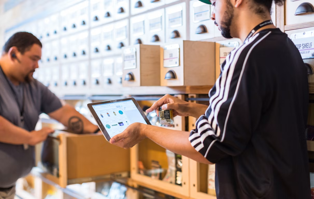 Warehouse team using a tablet to manage inventory for ecommerce orders and stock levels.