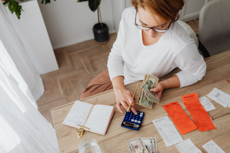 Homeowner reviewing expenses and creating a home repair budget for unexpected maintenance costs.