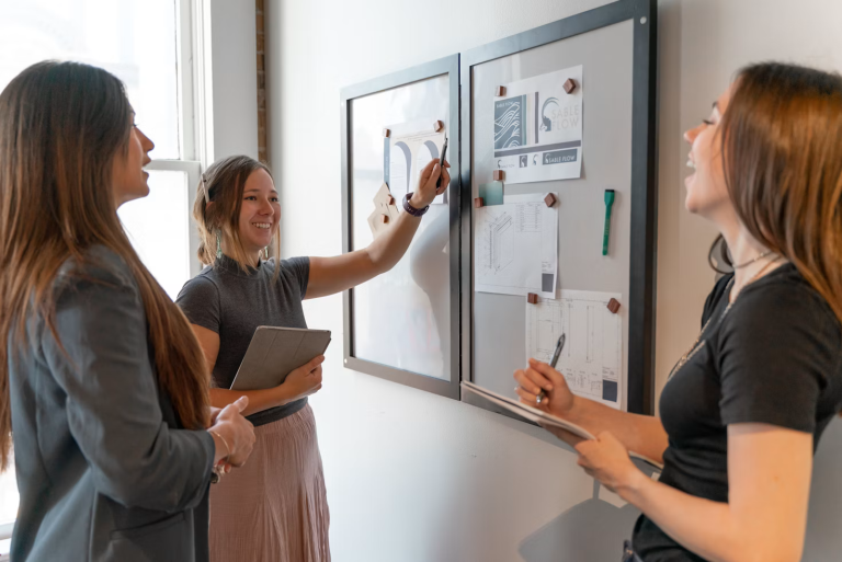 Team members planning a complex project using a visual project management board and collaborative planning tools.