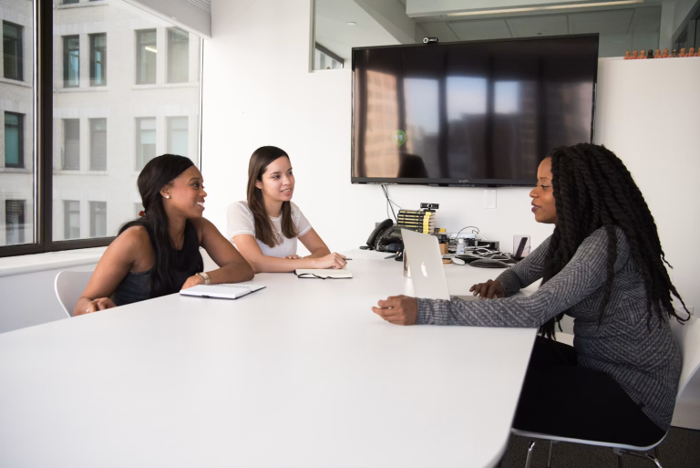 Business owner interviewing job candidates during a team meeting to hire employees for a small business.