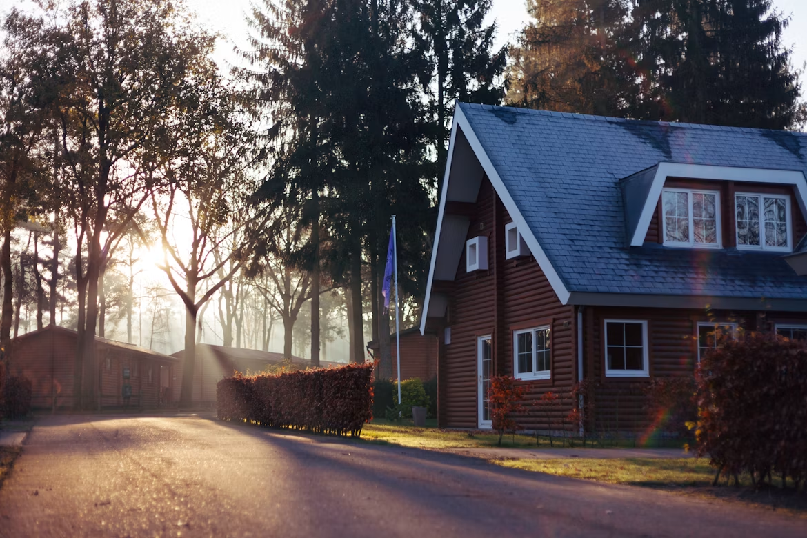A single-family home surrounded by mature trees in a quiet residential neighborhood.
