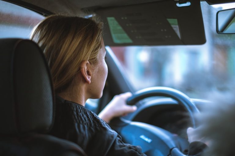 Woman driving a car after obtaining SR-22 insurance coverage
