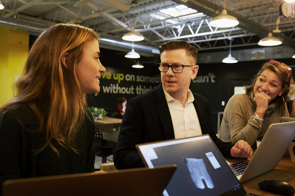 Business team collaborating with digital technology to scale a business through innovation and teamwork.