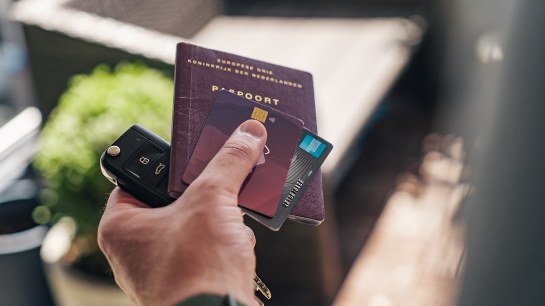 A person holding car keys and documents