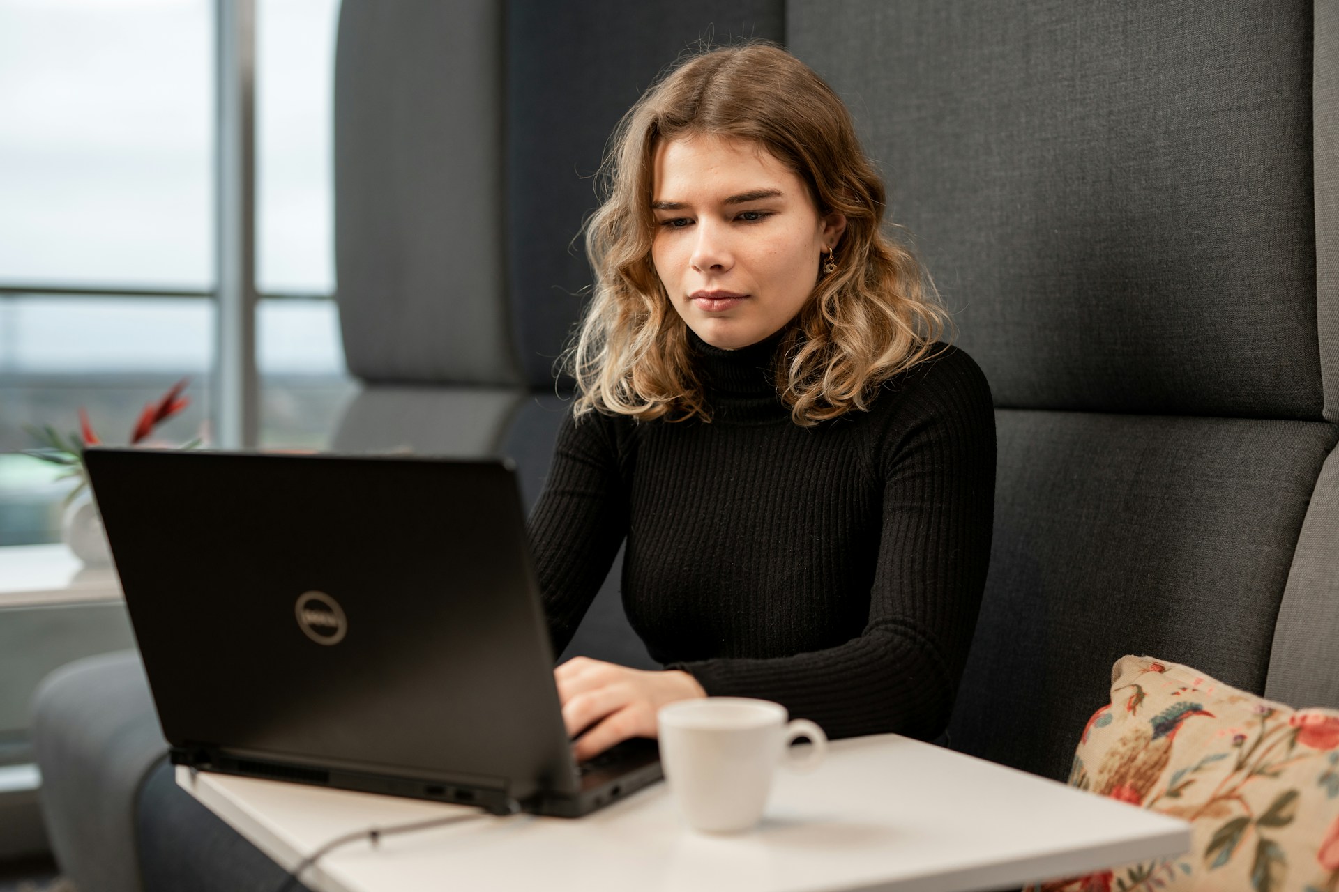 Woman working on a laptop while building and managing her business online