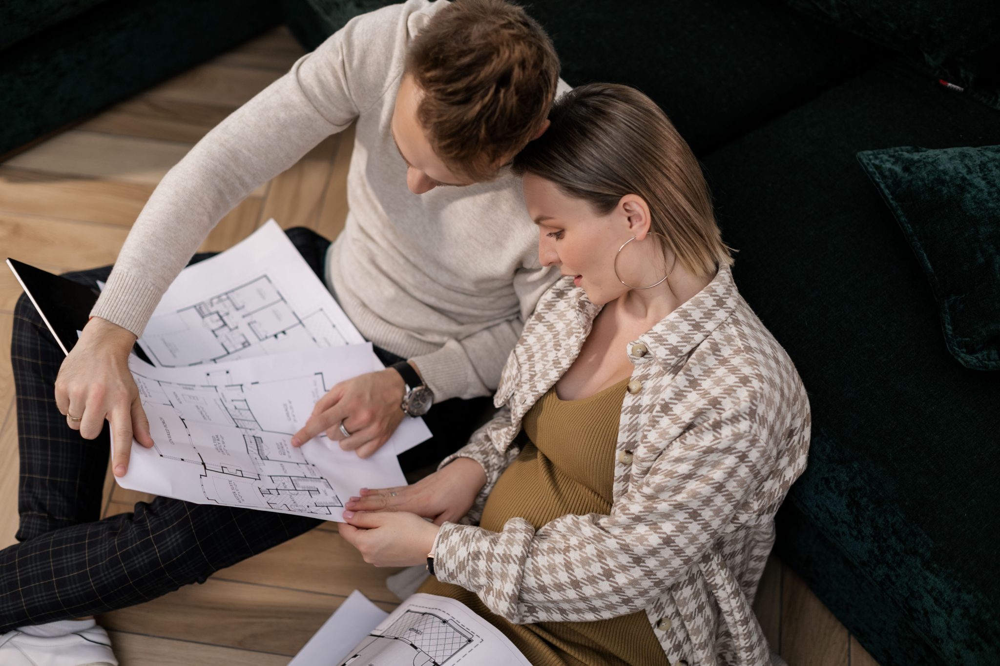 Couple reviewing custom home floor plans together while planning a house that fits their lifestyle.