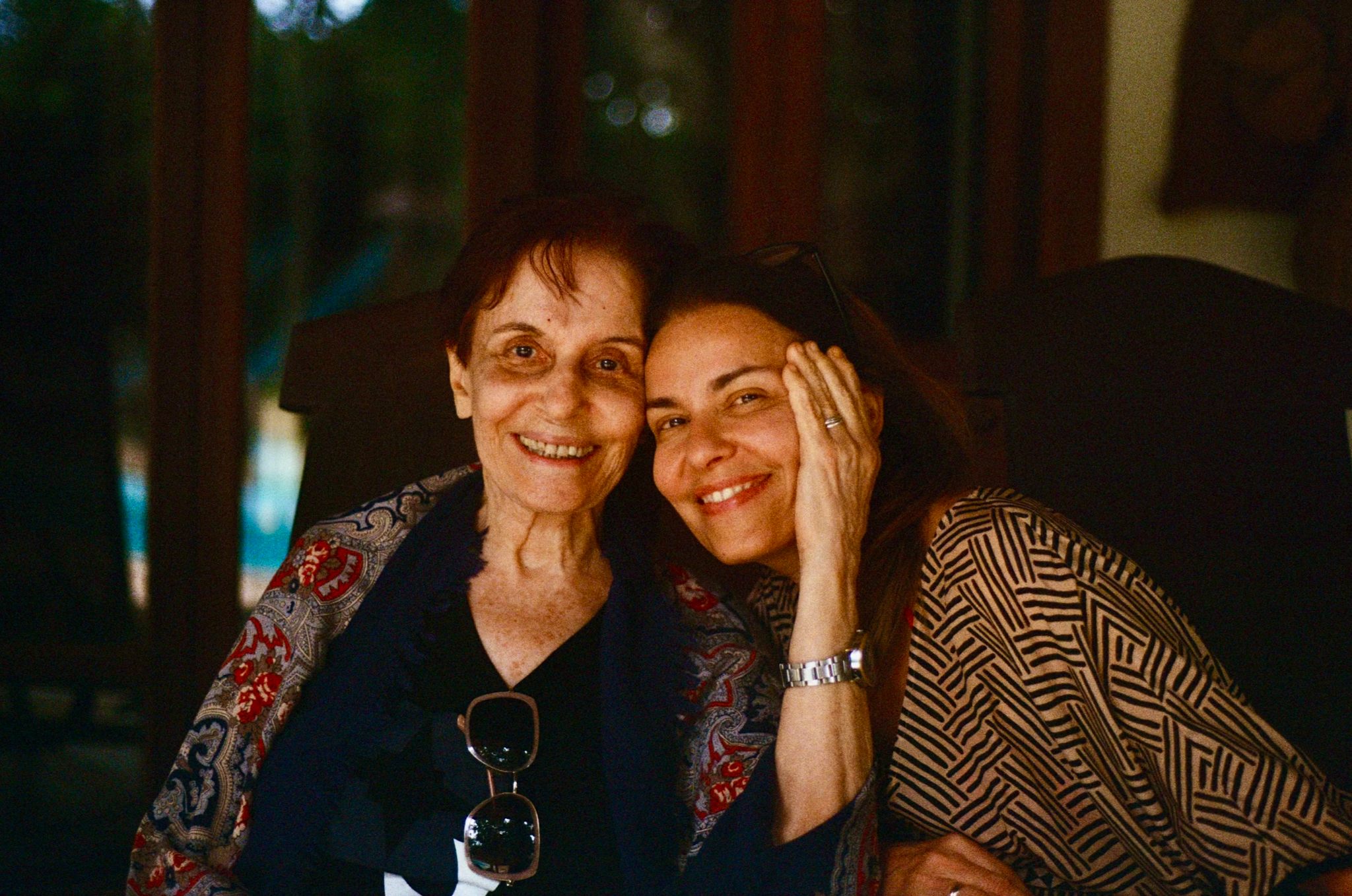 An adult daughter shares a warm moment with her aging mother, highlighting family support during life's transitions.