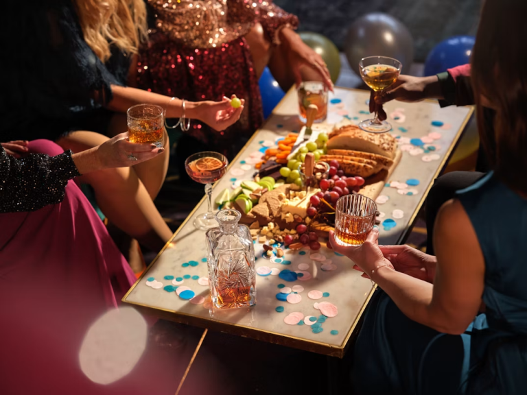 Guests gathered around a decorated table with food and drinks at a special celebration