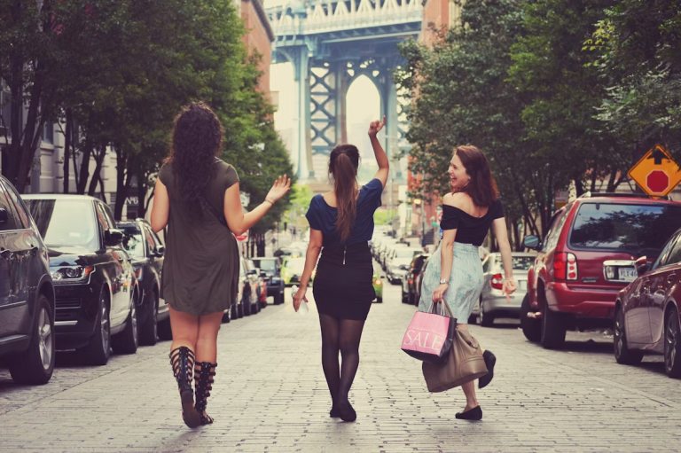 Three women enjoying a girls' getaway while exploring a city together