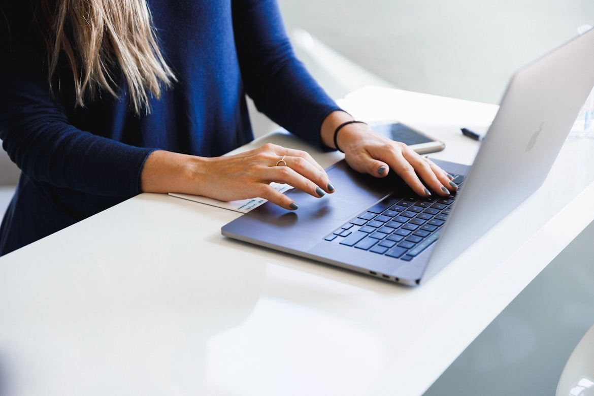 Woman using a laptop to compare graduate student loan options and repayment terms