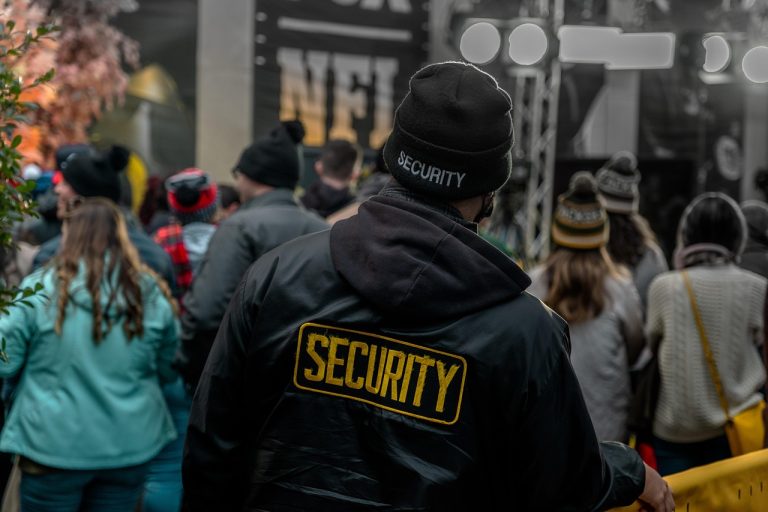 Security guard monitoring a crowd at an outdoor event
