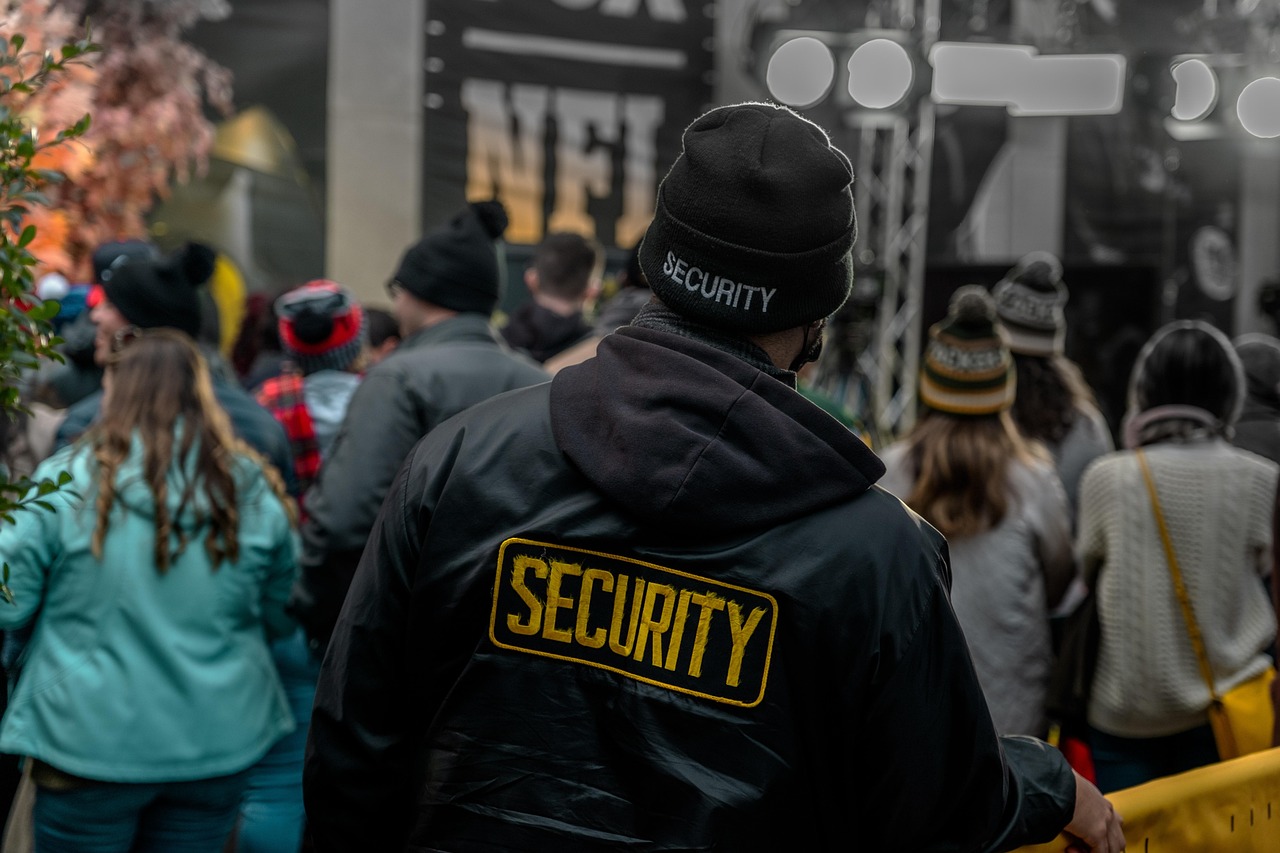 Security guard monitoring a crowd at an outdoor event